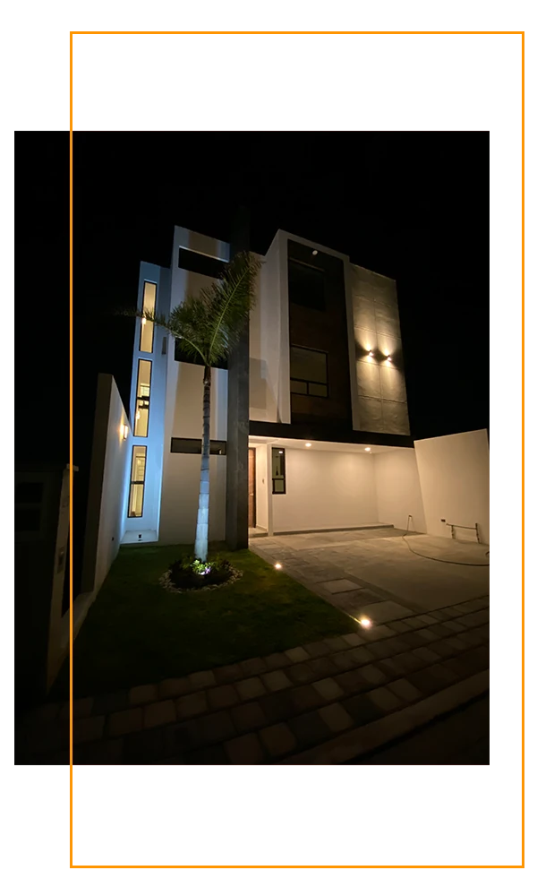 Fotografía de la fachada de la casa Jazmín 16 con iluminación nocturna